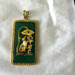 Jade necklace gold & green 1” by one and 3/4 says, "Good luck and long life"